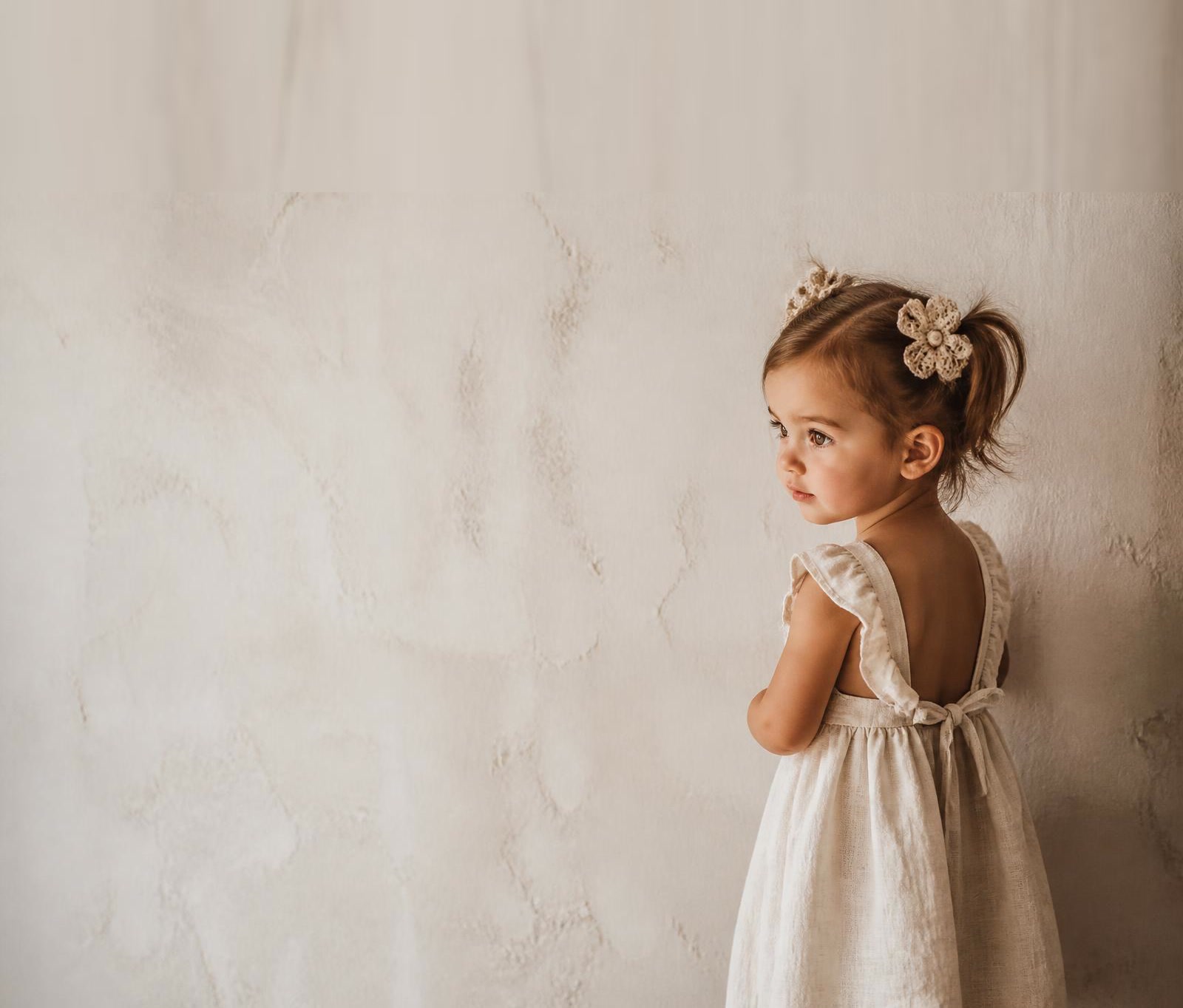 Toddler girl wearing Elle & Ivy hair accessories in soft natural light