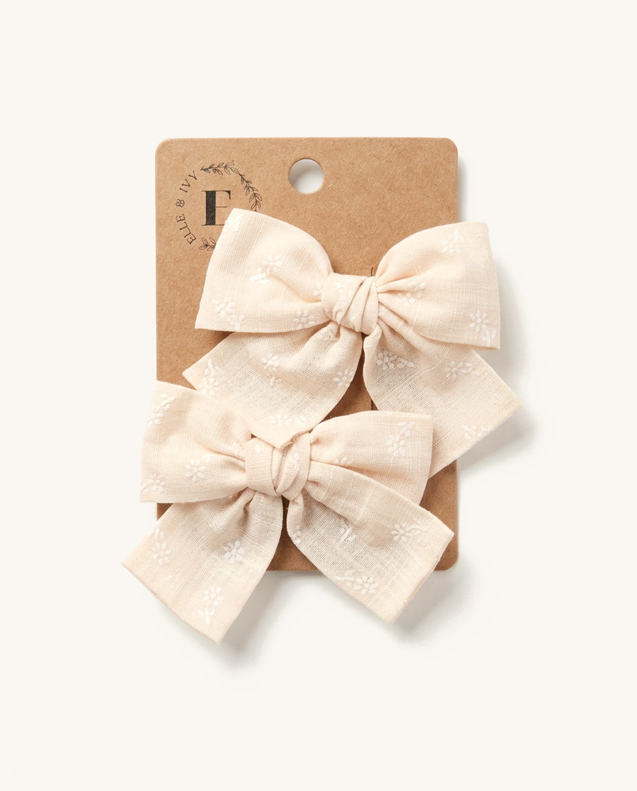 Blush Eyelet Daisy Bow Set — on the Elle & Ivy packaging card